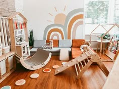 a living room filled with lots of furniture and decor on top of hard wood flooring