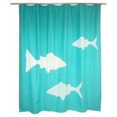 a shower curtain with fish on it in blue and white colors, against a white background