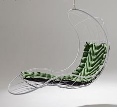 a chair with green cushions hanging from it's back and the seat is shaped like a boat