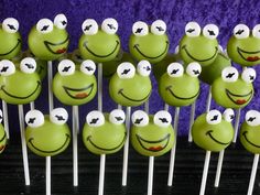 there are many green cake pops with faces on them