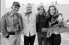 black and white photograph of four people standing together