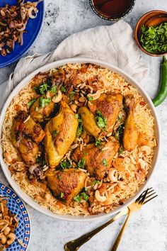 a bowl filled with chicken and rice next to other dishes