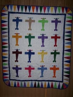 a cross quilt is hanging on the wall