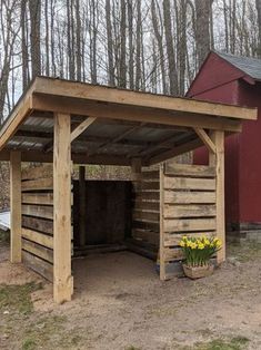 a wooden shed with flowers growing out of it