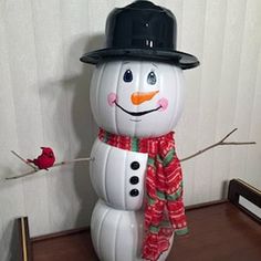 an inflatable snowman wearing a top hat and scarf