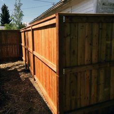 a wooden fence next to a white house