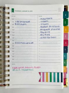 an open planner book with colorful stickers on the pages and numbers for each month