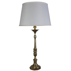 a gold lamp with a white shade on it's base and a white lampshade