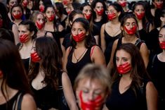 a group of women with red painted faces