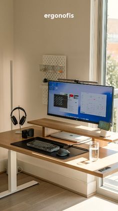 a computer monitor sitting on top of a wooden desk