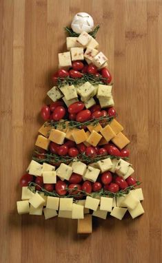 a christmas tree made out of cheese and tomatoes