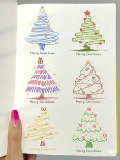 someone is holding up a book with christmas tree designs on it and the words merry christmas written in different colors