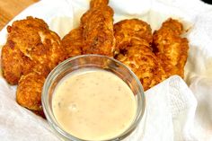 fried chicken sticks with dipping sauce in a glass bowl