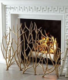 the fireplace is decorated with gold branches