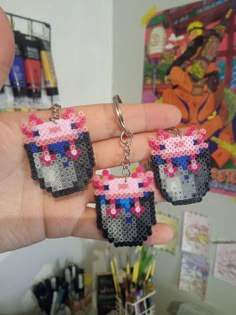 a person holding some kind of earrings in their hand and it looks like they have been made out of legos