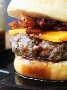 a hamburger sitting on top of a black plate