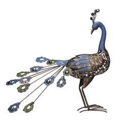 a metal peacock with feathers and jewels on it's tail, standing in front of a white background