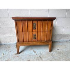 an old wooden cabinet with two drawers