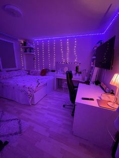 a bedroom with purple lights and a bed in the corner, next to a desk