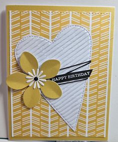 a close up of a greeting card with a heart and flower on the front, which reads happy birthday