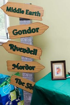 a wooden sign that says middle earth, gondor, riverdale, mirror, the sky