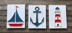 three pieces of wood with an anchor, sailboat and lighthouse on the front one is painted red white and blue