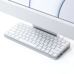 a computer keyboard sitting on top of a white desk