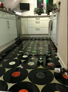 a kitchen with black and white polka dots on the floor