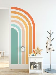 an open door to a room with rainbow stripes on the wall and stars in the floor