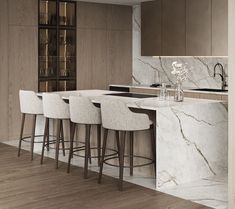 a kitchen with marble counter tops and bar stools