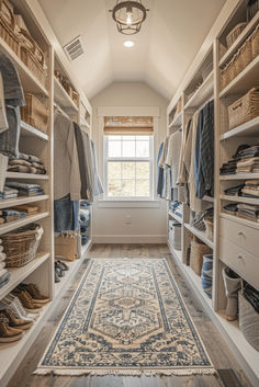 a walk in closet with lots of clothes and rugs