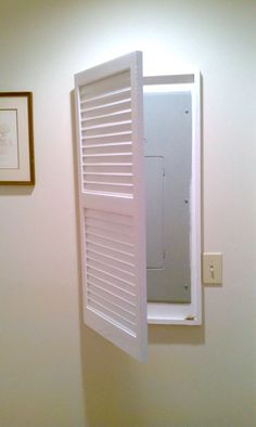 a bathroom with a white toilet sitting next to a window