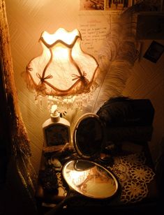 a lamp that is sitting on top of a table next to some other items in a room