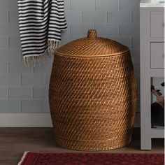 a woven laundry basket next to a white cabinet