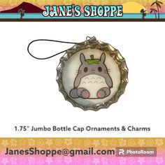 a bottle cap ornament with an image of a totoro on it