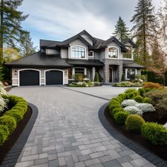 a large house with lots of trees and bushes around it's driveway area in the front yard