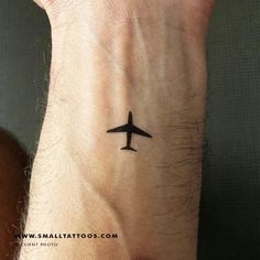 an airplane tattoo on the wrist