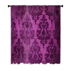 a purple and black wall hanging on a white wall