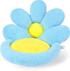 a blue flower shaped pillow with yellow center