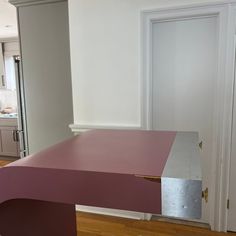 a pink table in the middle of a room