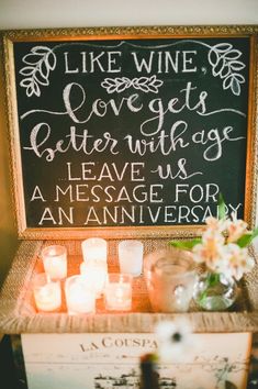 a chalkboard sign that says like wine covers better with age leave us an message for an anniversary