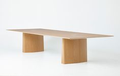 a wooden table sitting on top of a white floor