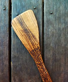 a wooden spatula sitting on top of a wooden table