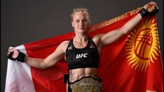 a woman holding a flag in front of a black and red background with gold accents