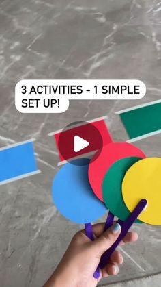 someone is holding up some colorful pieces of paper with the words 3 activities - 1 simple set up