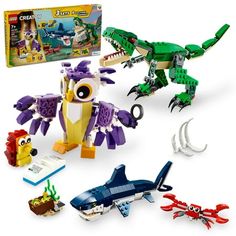 an assortment of legos and toys including a toy shark, crocodile, and alligator