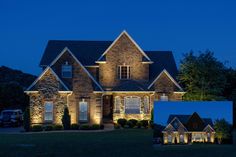 a large brick house lit up at night