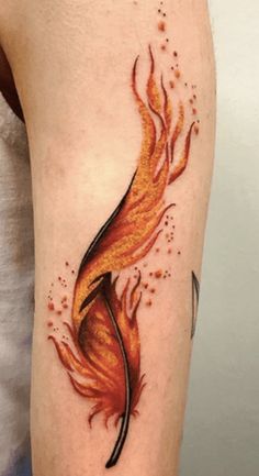 a woman's arm with a firebird tattoo on the left side of her body