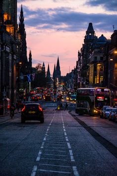 a city street filled with traffic at dusk