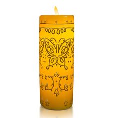 a yellow candle with an intricate design on it